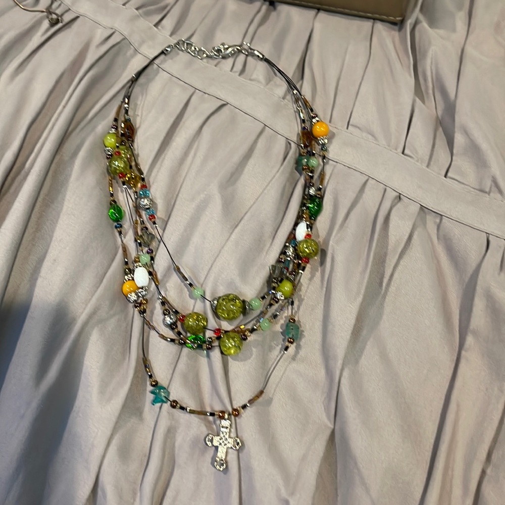 Layered beaded cross necklace.